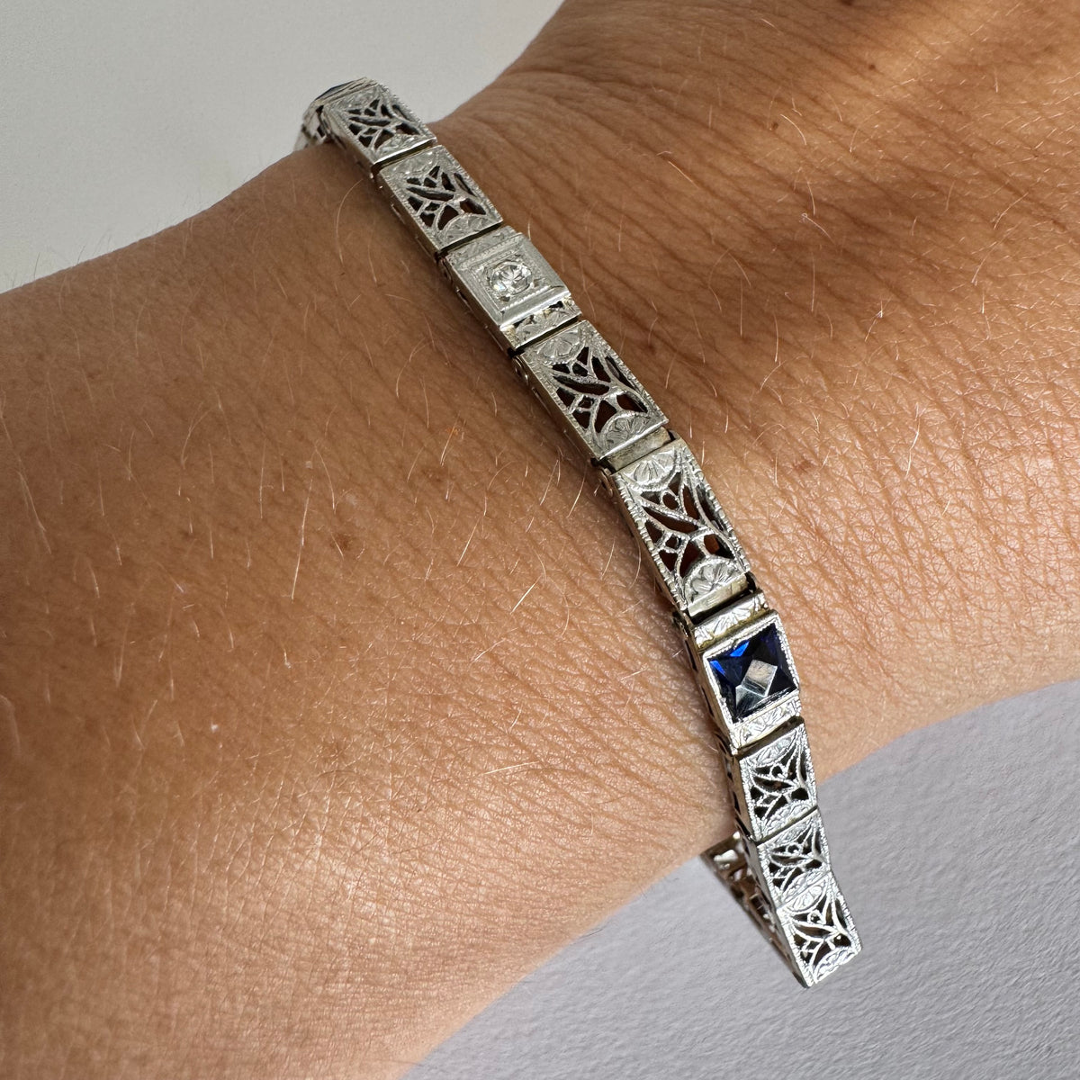14K gold bracelet featuring intricate openwork and beautifully engraved details set with Sapphire & Diamonds
