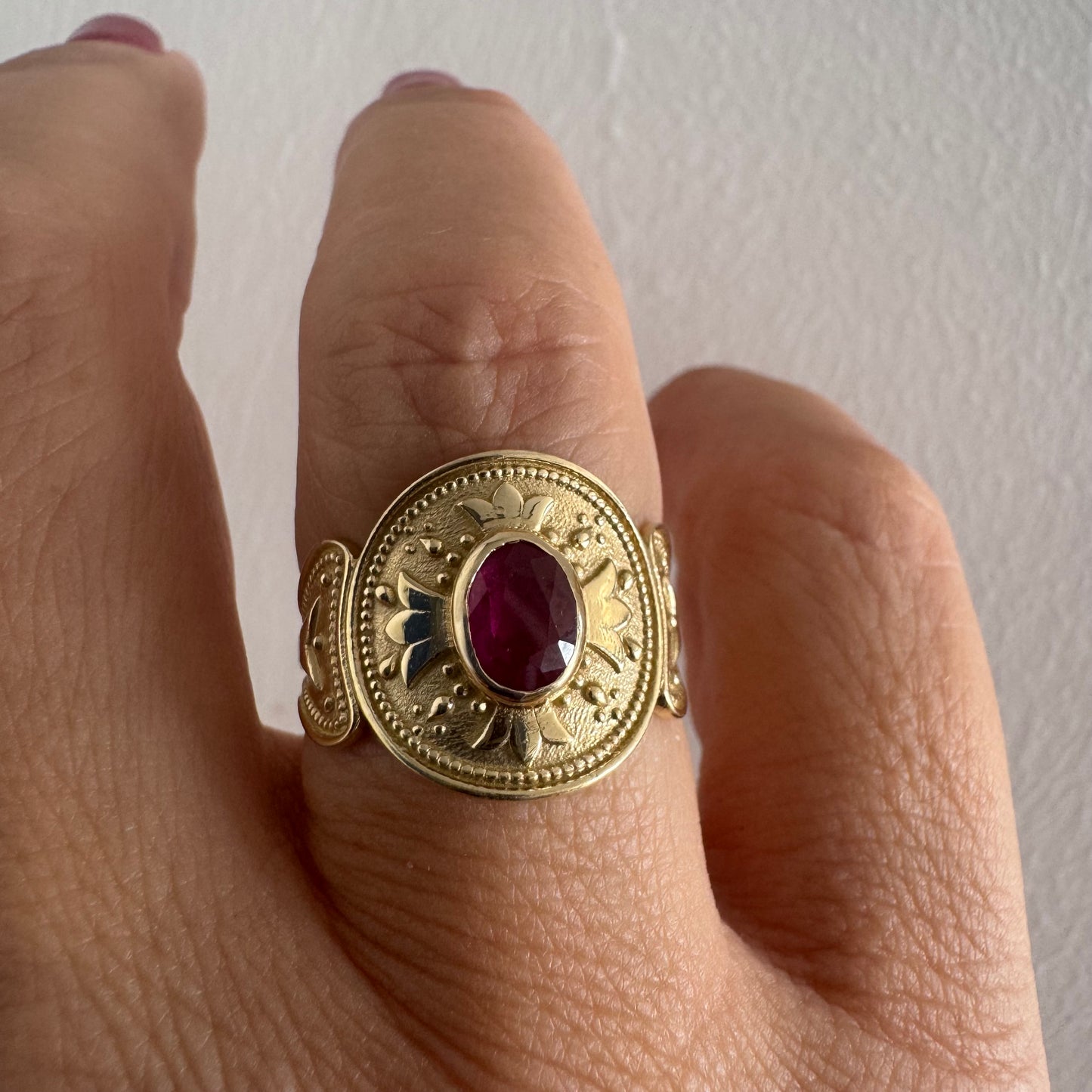 14K gold ring set with an oval Ruby
