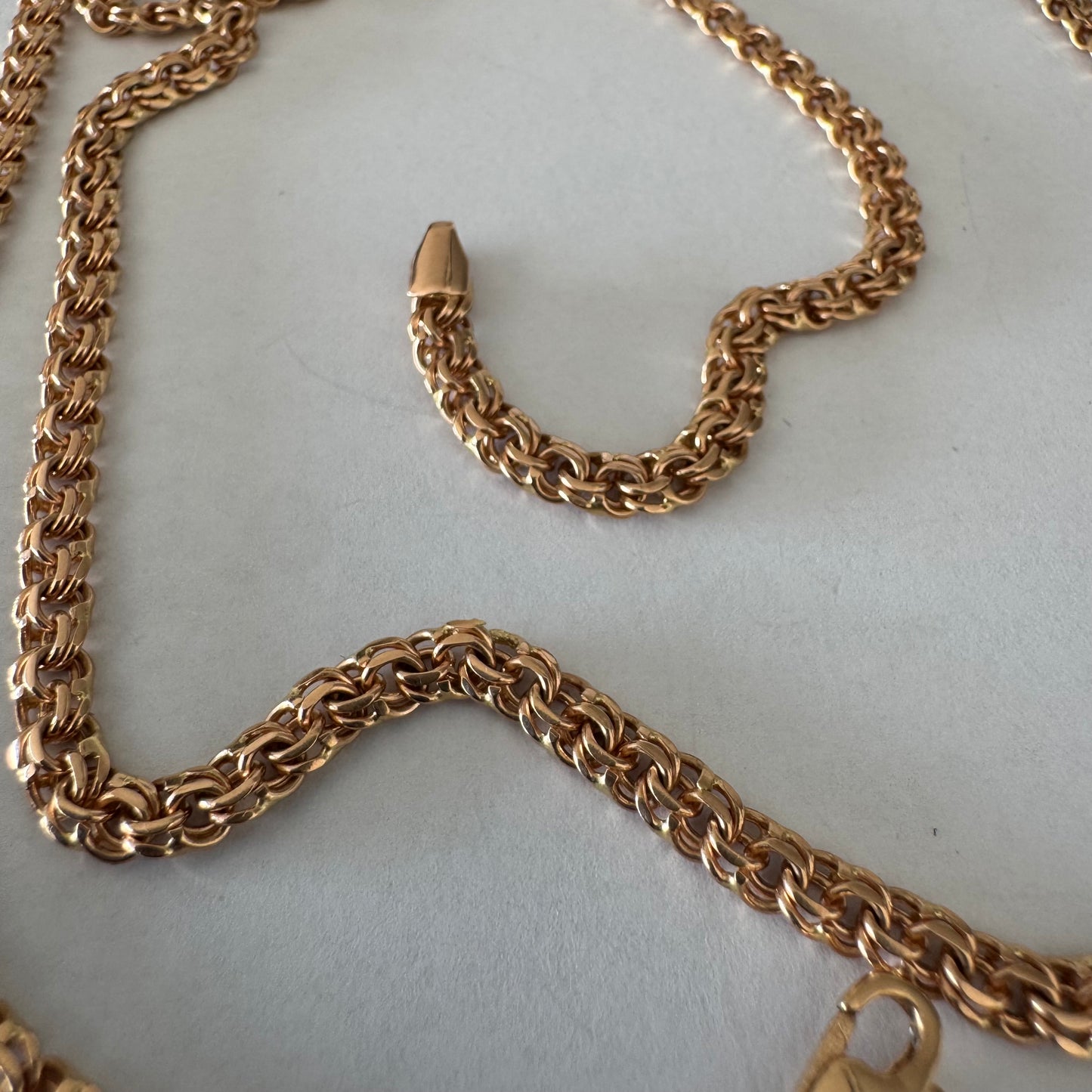 14K gold chain featuring an intricate woven link
