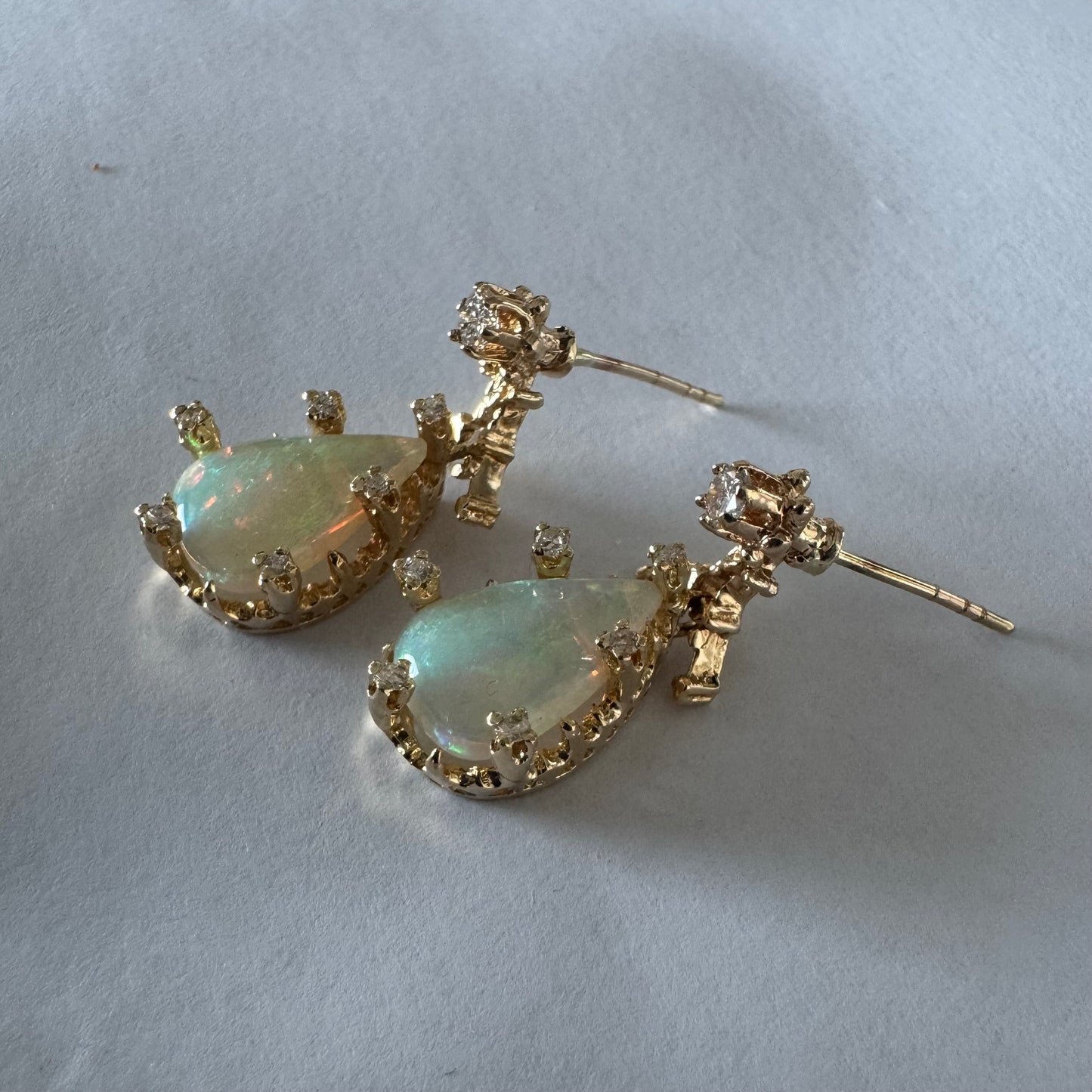 14K gold drop earrings set with pear-shaped Opals and Diamonds.