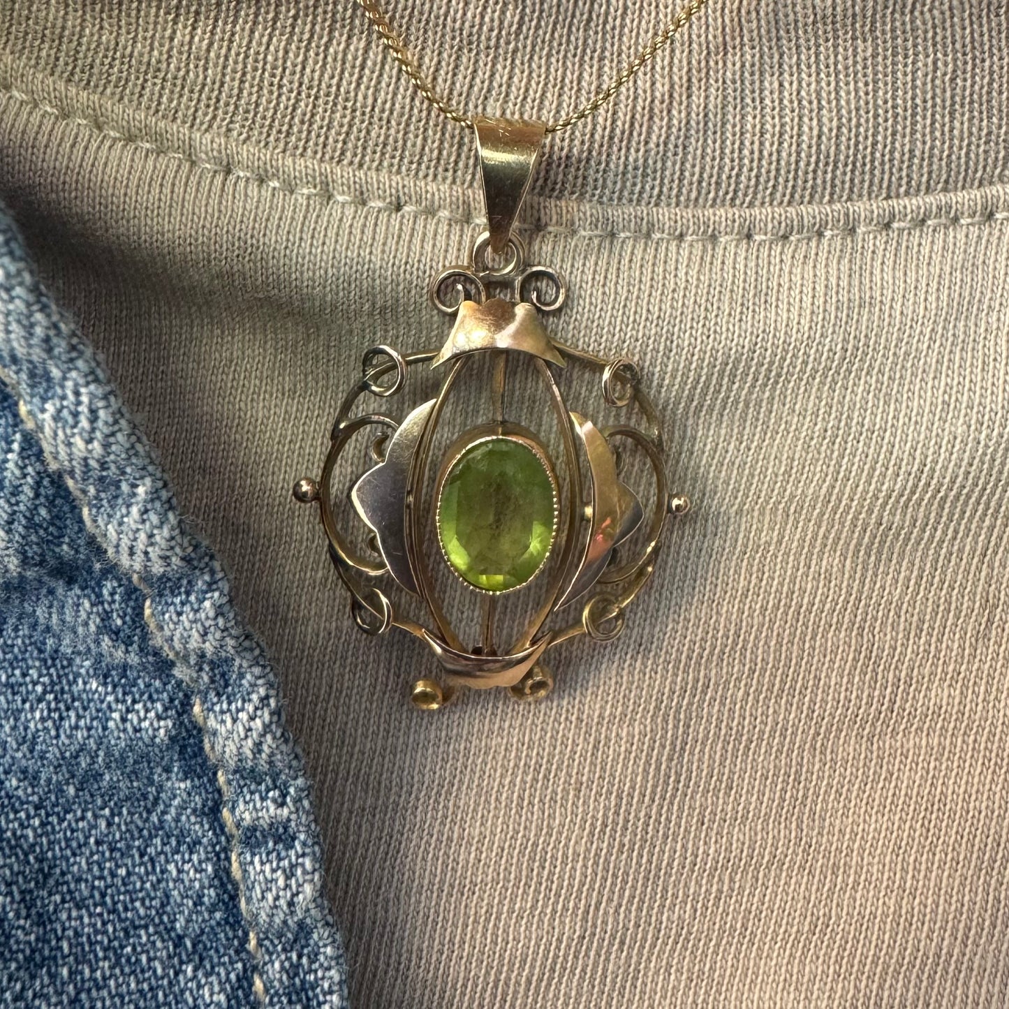 9K gold pendant featuring an oval-cut Peridot in a vibrant green hue.