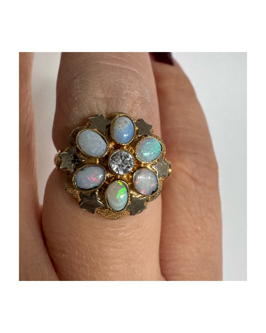 14K gold ring set with natural Opal stones and a central Diamond.