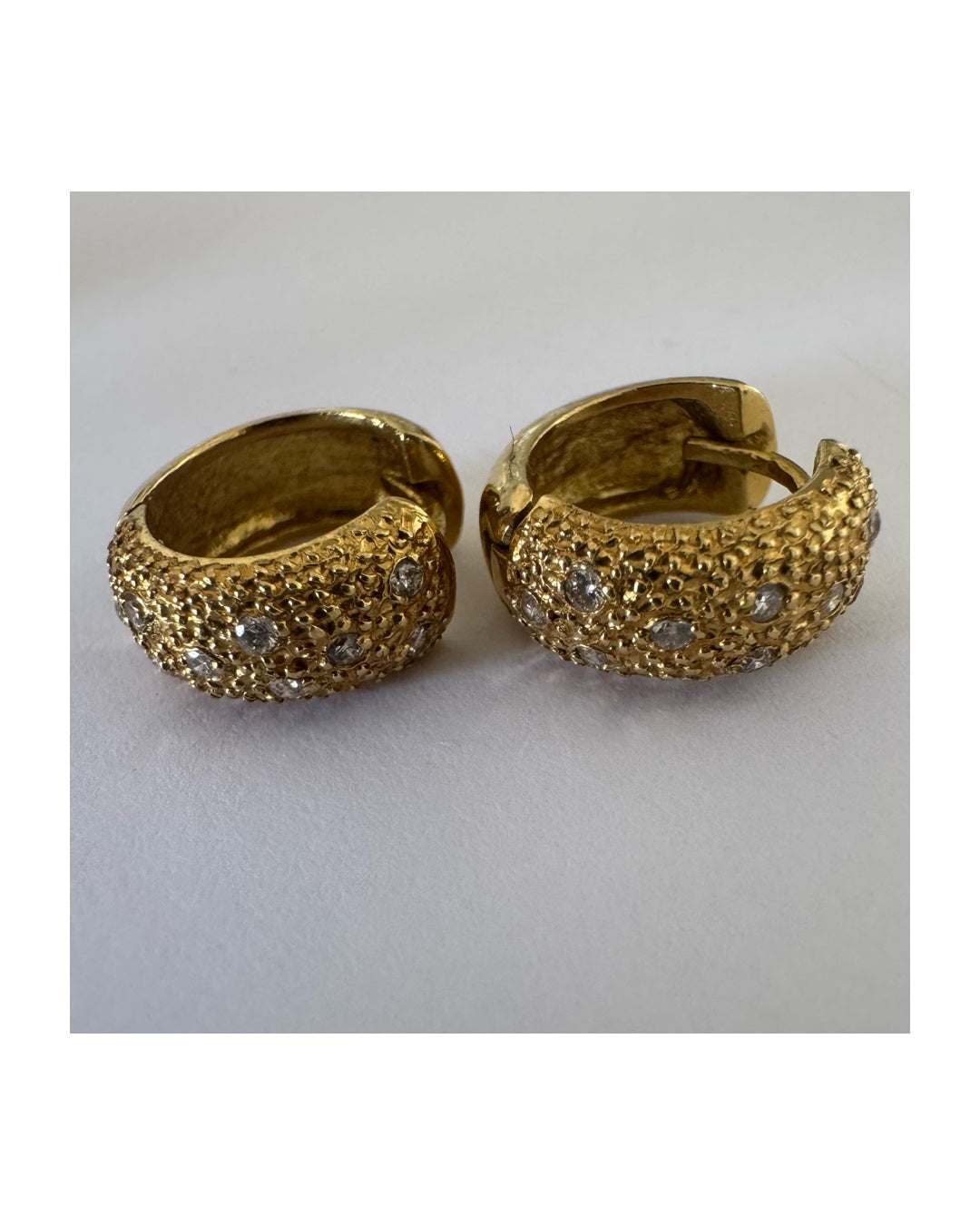 18K gold hoop earrings designed with a rich organic texture and set with Diamonds