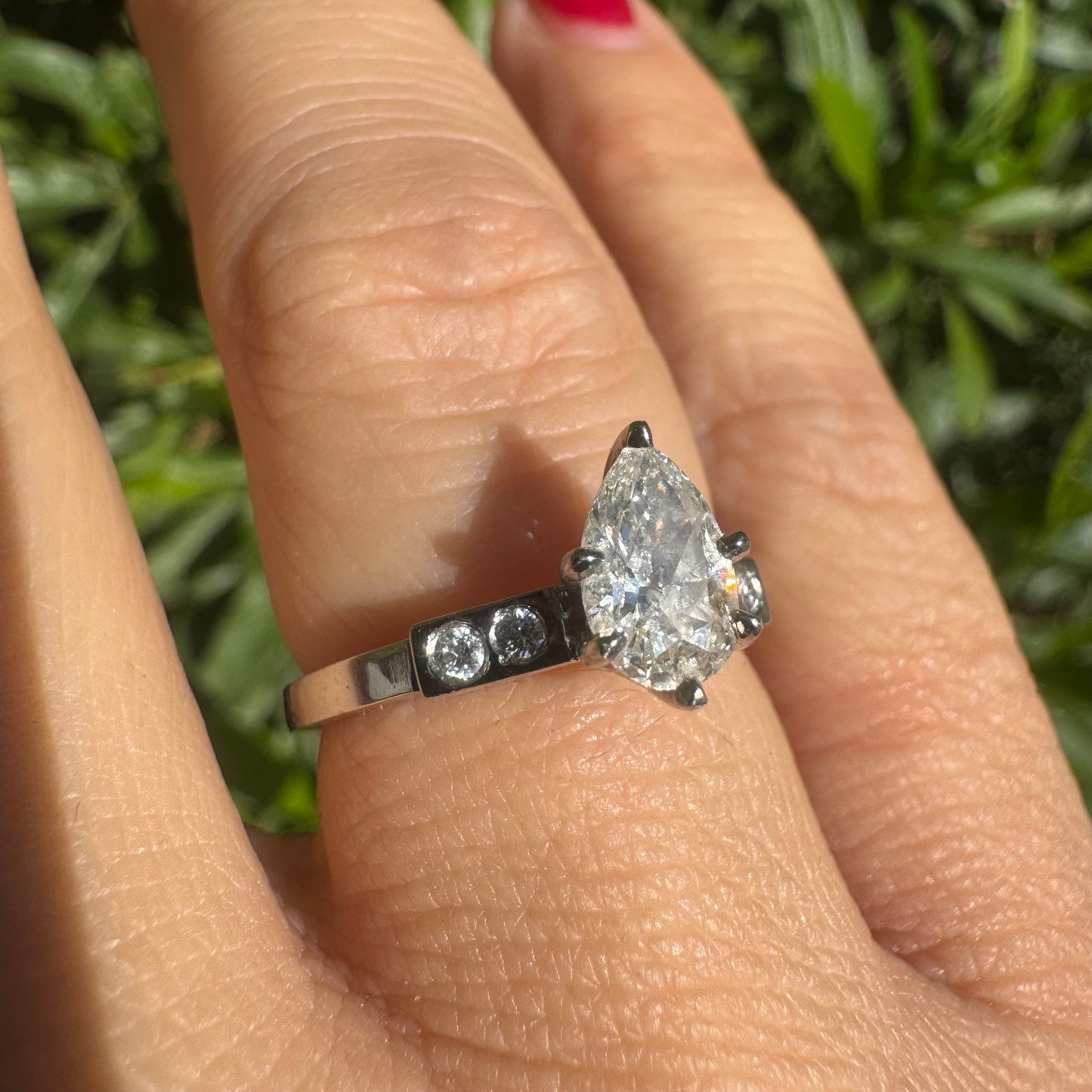 Platinum ring set with one center Pear cut Diamond & side Diamonds