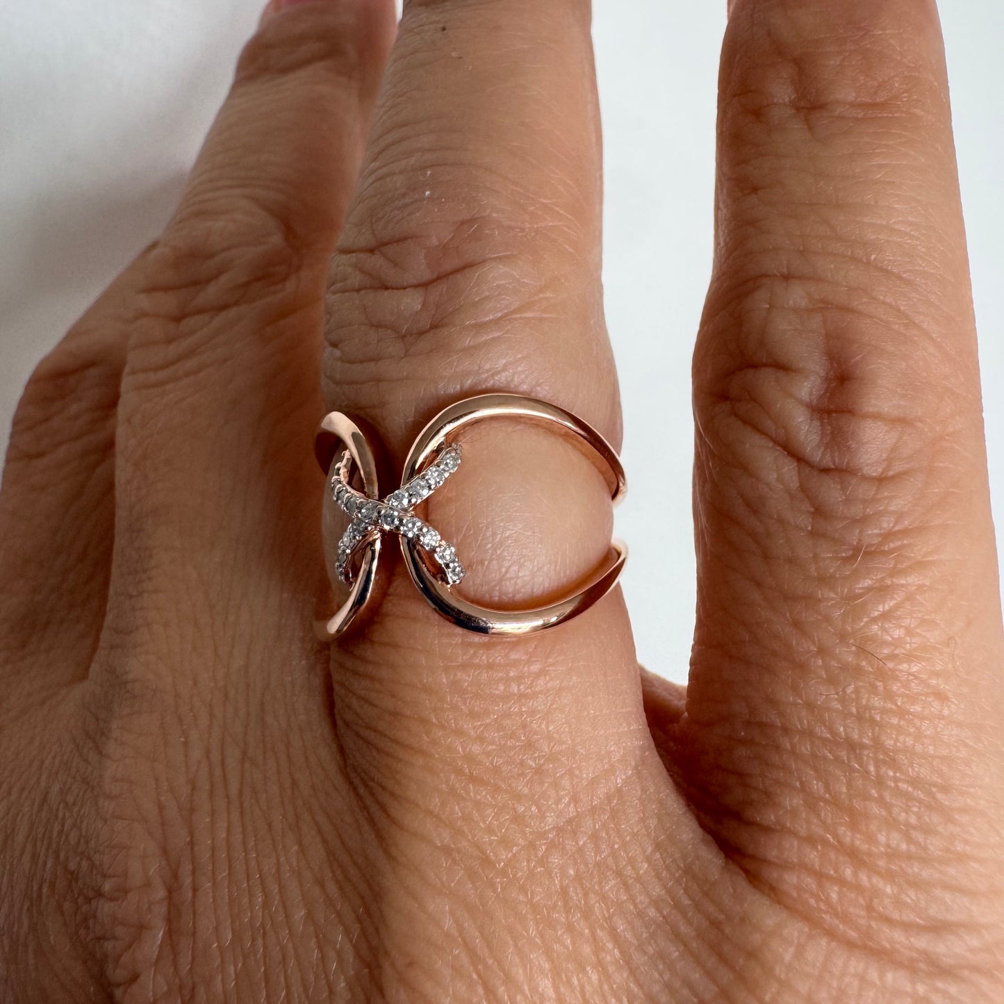 10K rose gold ring set with natural Diamonds in a flowing & artistic design.
