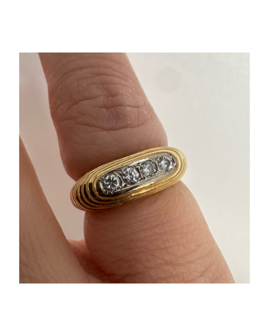 14K gold elongated oval ring set with five round Diamonds in a channel setting.