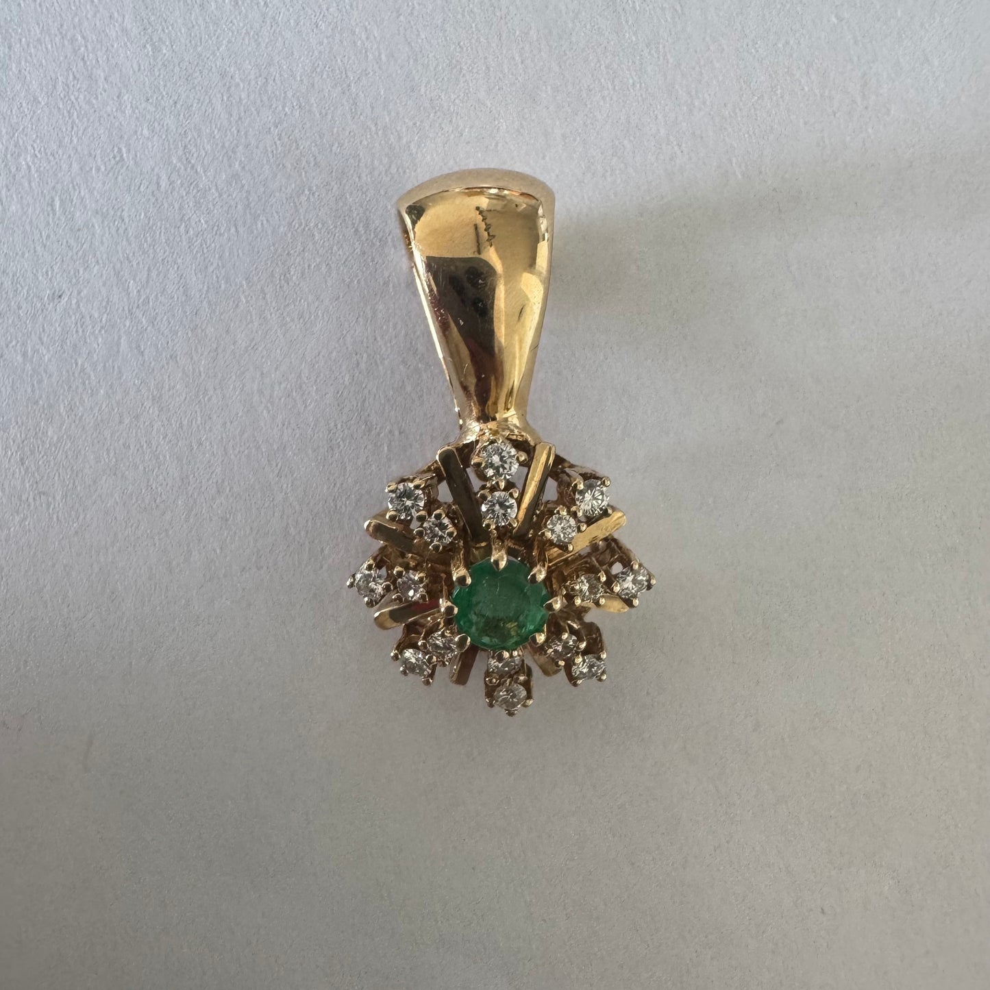 14K gold pendant centered with a Emerald and surrounded by a halo of sparkling Diamonds