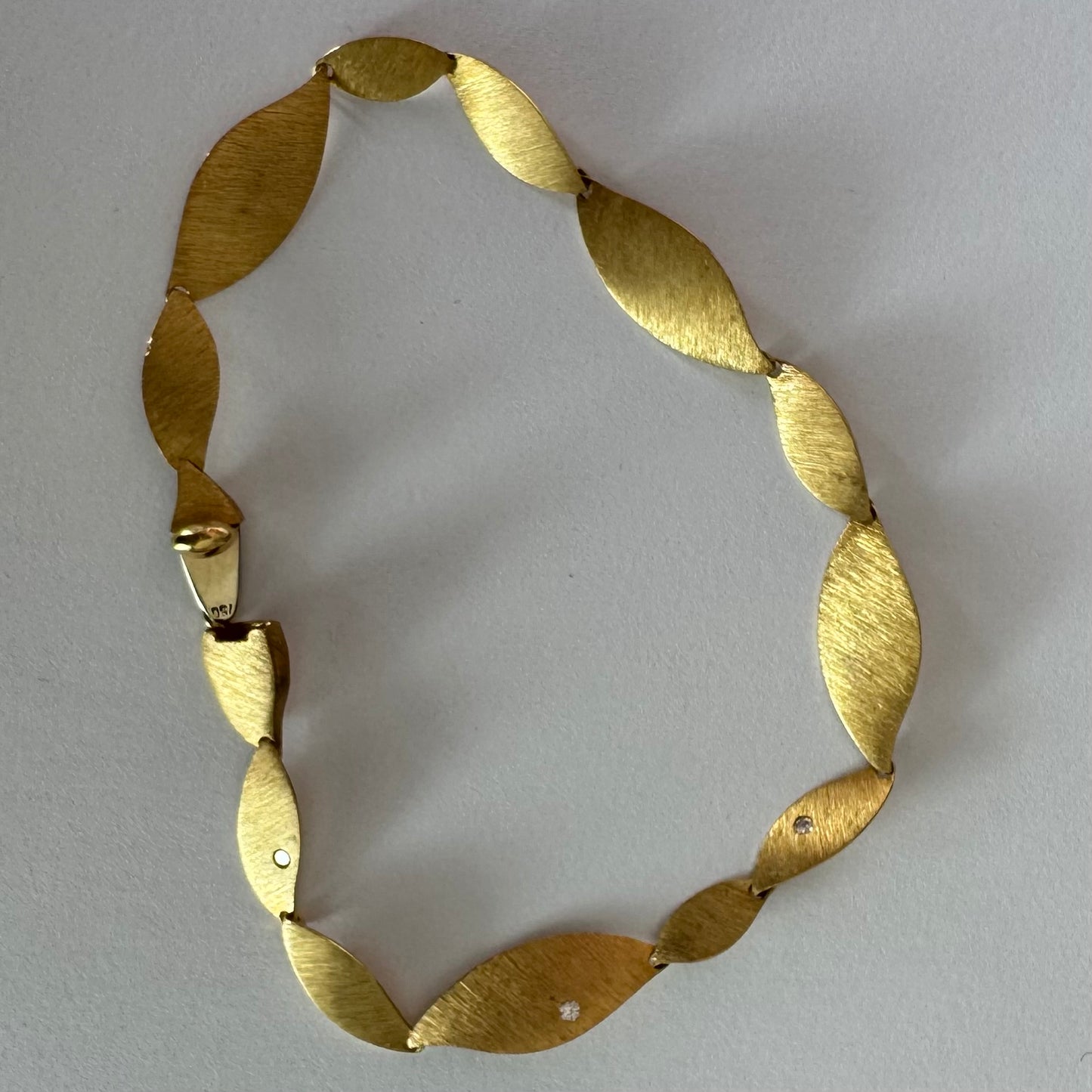 צמיד יוקרתי של המותג H.Stern, עשוי זהב 18 קראט, בעיצוב עלים מחוספסים במראה משי מט. 