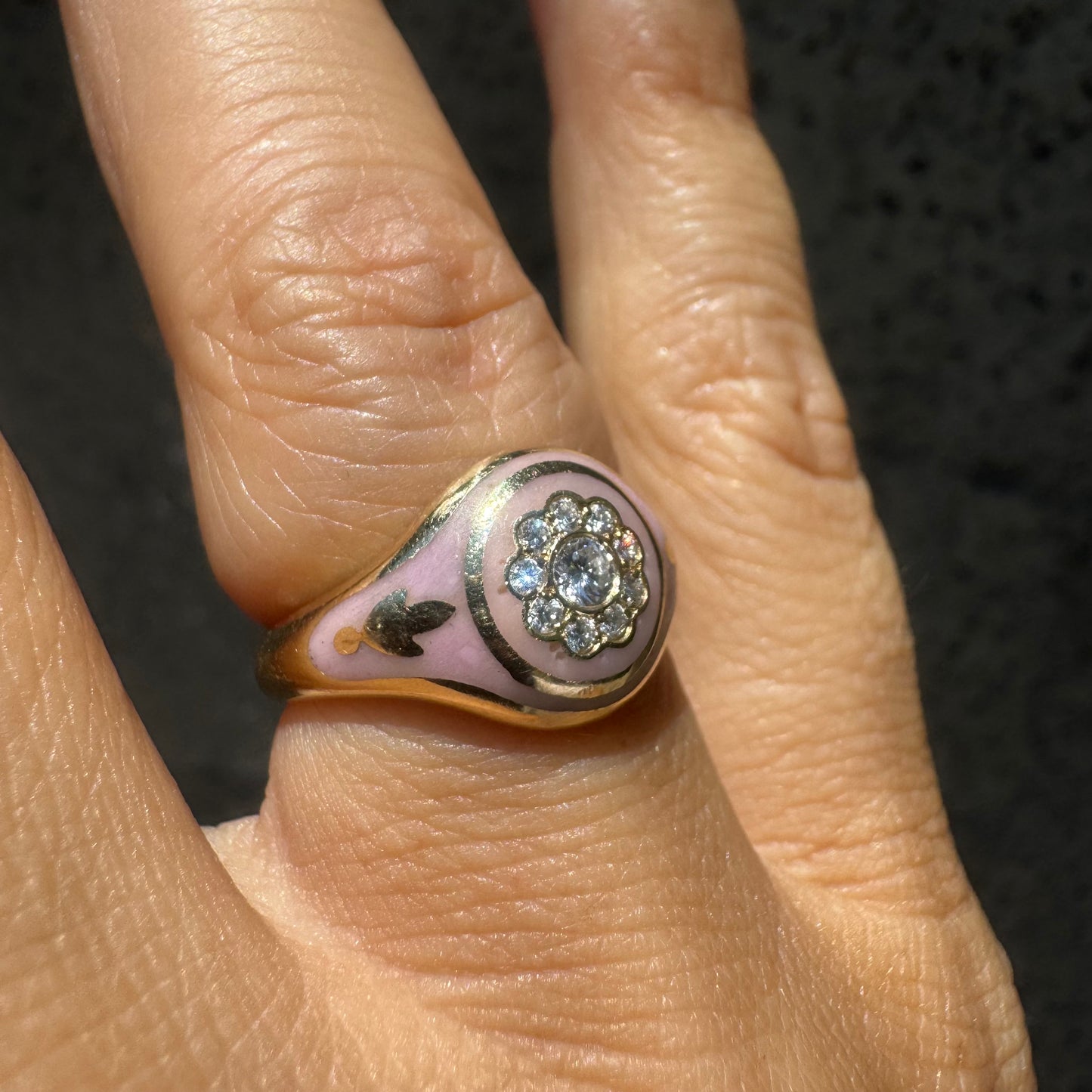 14K gold ring set with soft pink enamel & Diamonds with floral motif at the center.