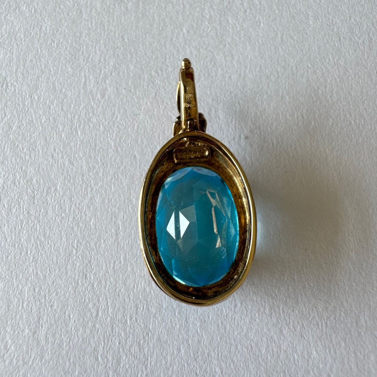 9K gold Pendant set with a striking oval-cut Blue Topaz