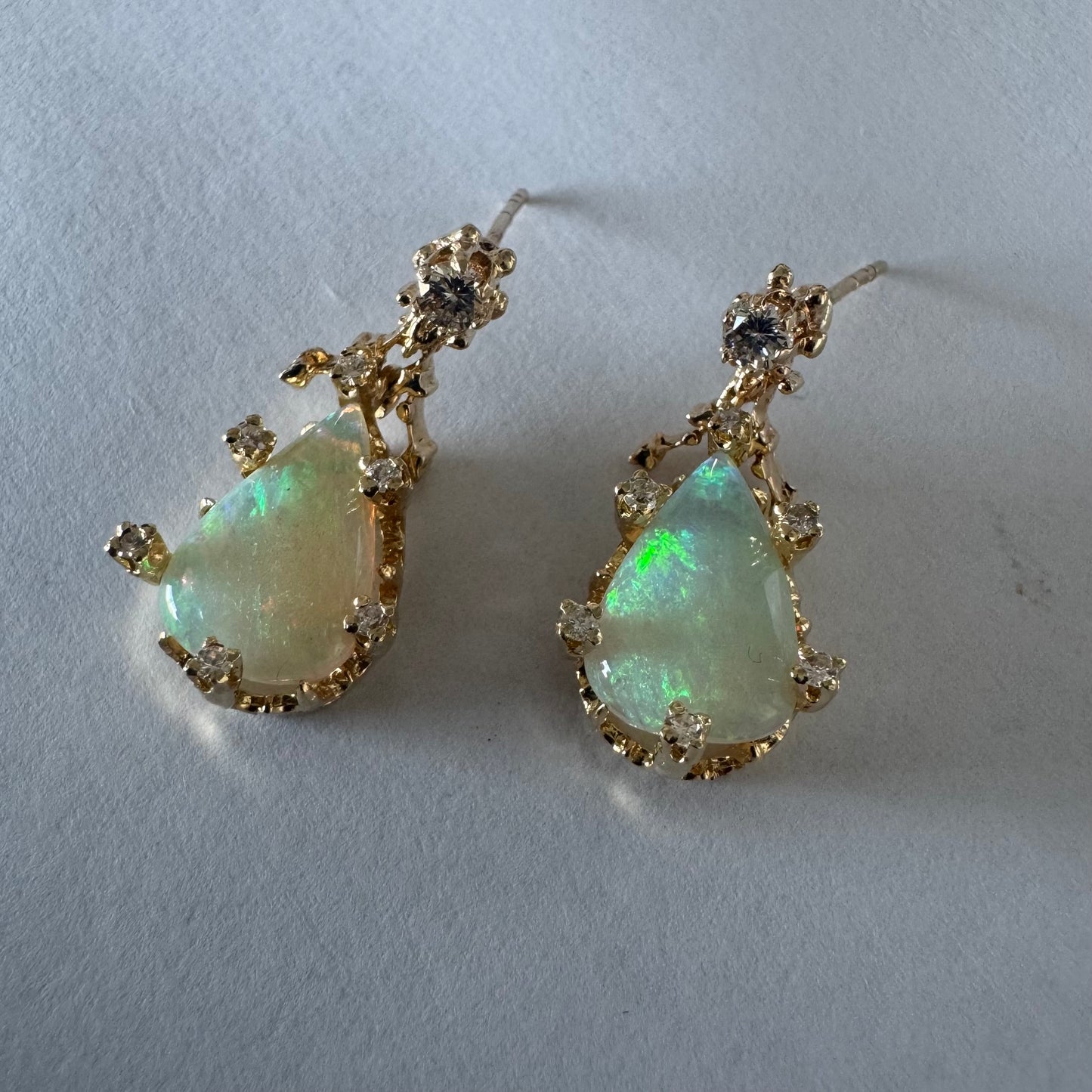 14K gold drop earrings set with pear-shaped Opals and Diamonds.