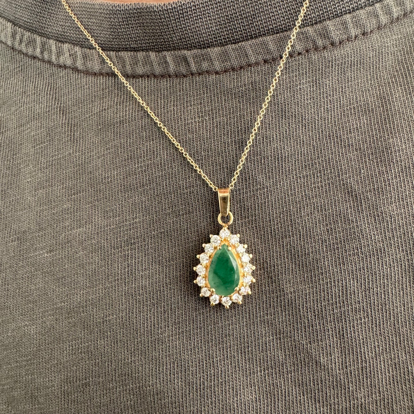 14K gold necklace set with a pear-cut Emerald, surrounded by sparkling lab-grown Diamonds.