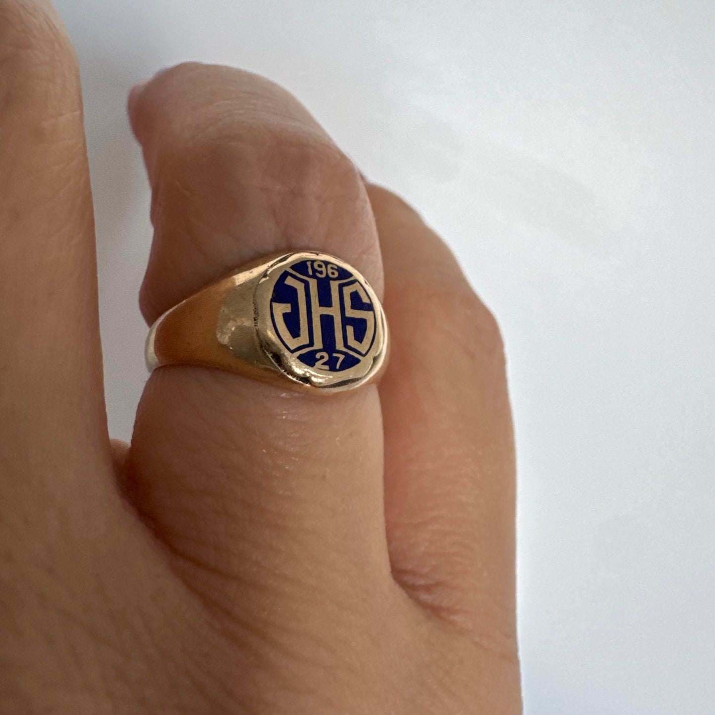 14K gold signet ring featuring an oval face with dark enamel and bold engraved initials at the center.