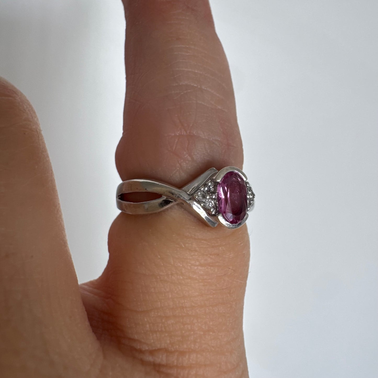 9K gold ring set with a pink center stone