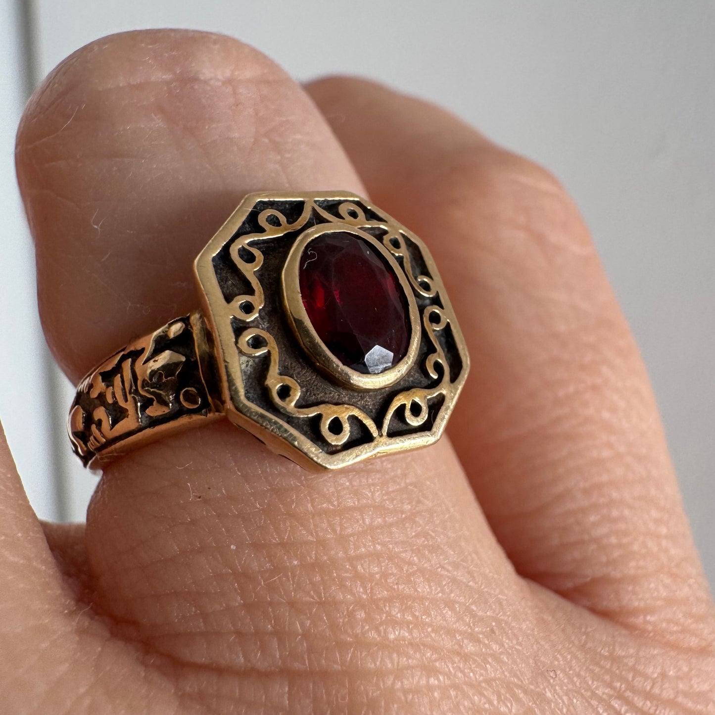 14K gold ring set with an oval deep-red Garnet.