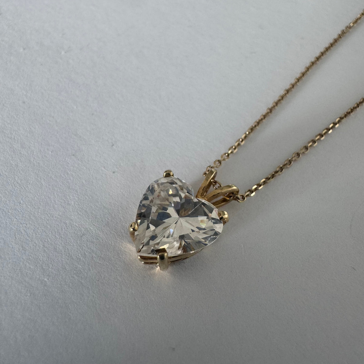14K gold Heart Pendant set with a brilliant heart-cut clear stone.