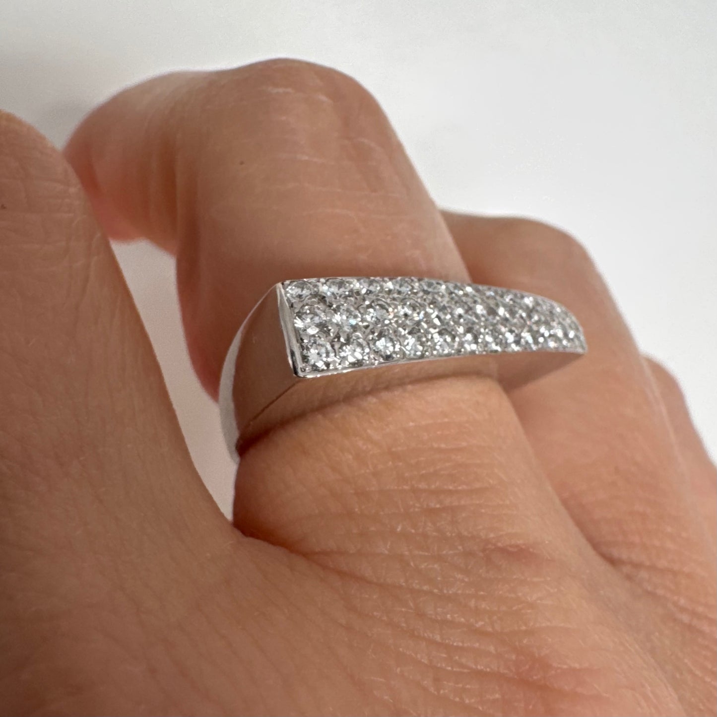 18K white gold band fully set with pavé diamonds across the surface.