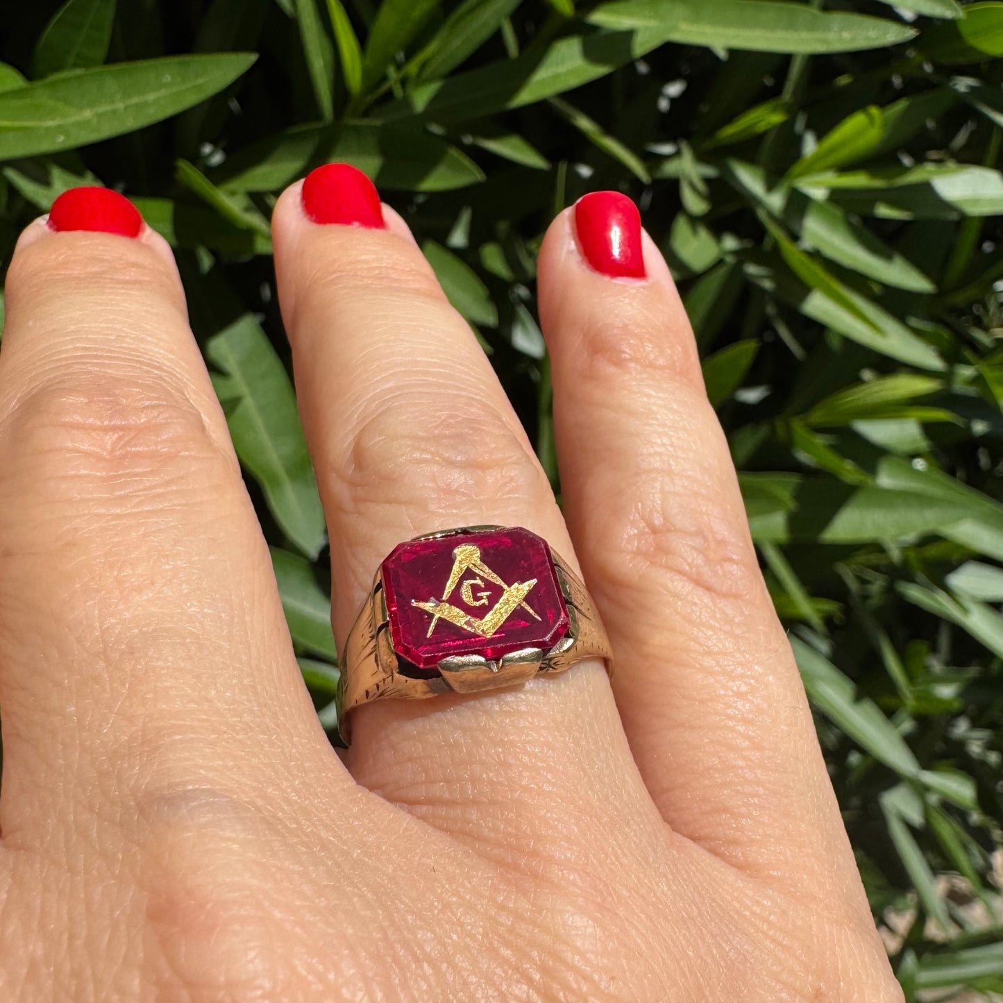 10K gold “Freemason” ring set with red gemstone with the iconic compass square and the letter “G” in gold