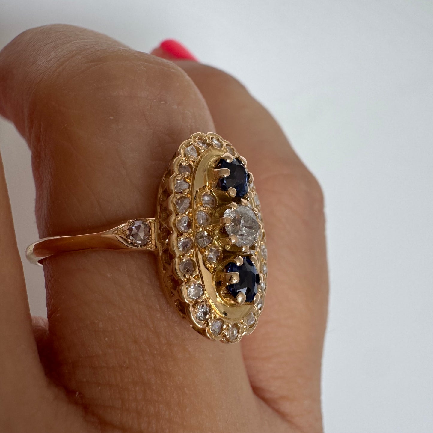 14K gold ring set with Diamonds and deep blue Sapphires in a classic oval design.