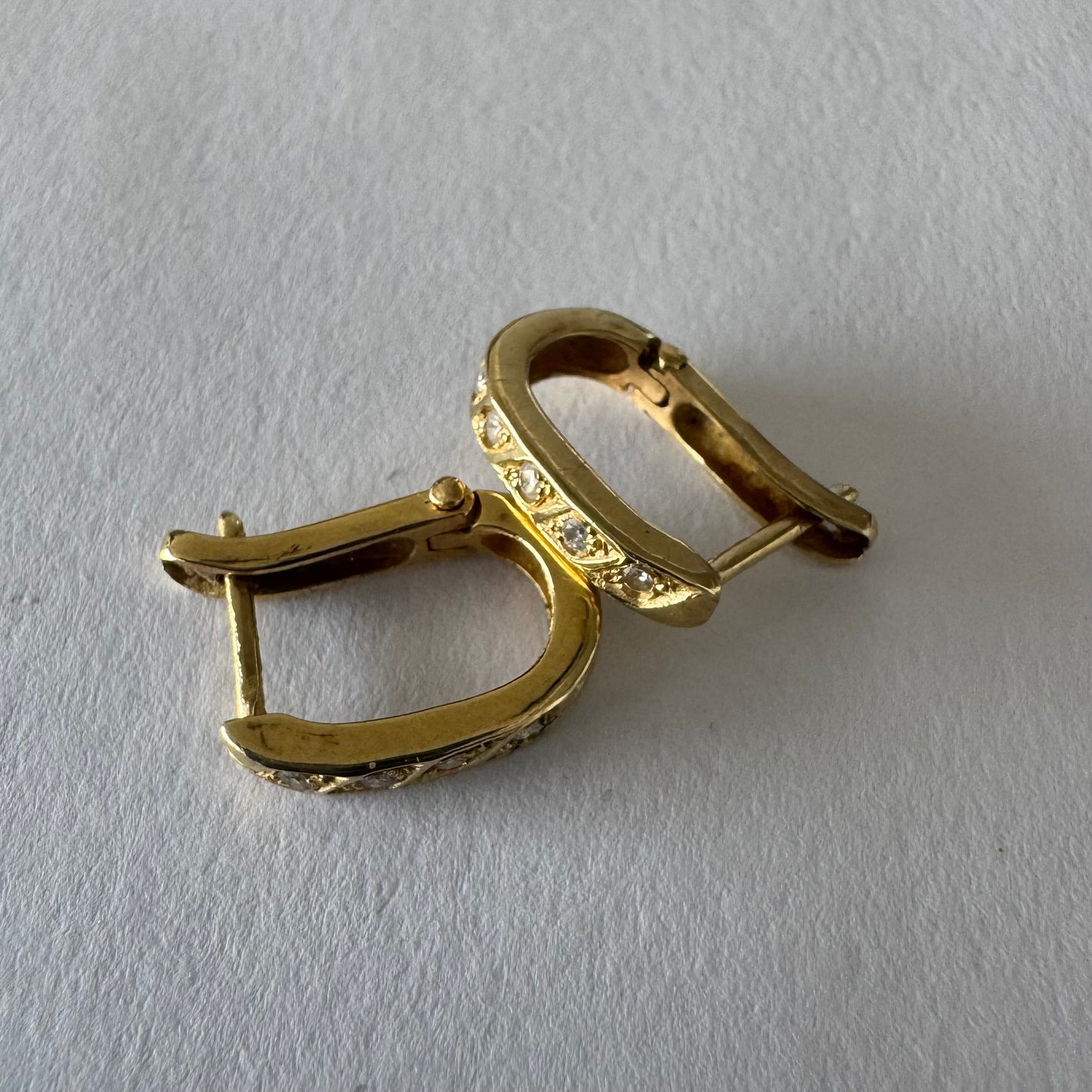 14K gold huggie earrings accented with a delicate row of sparkling Diamonds