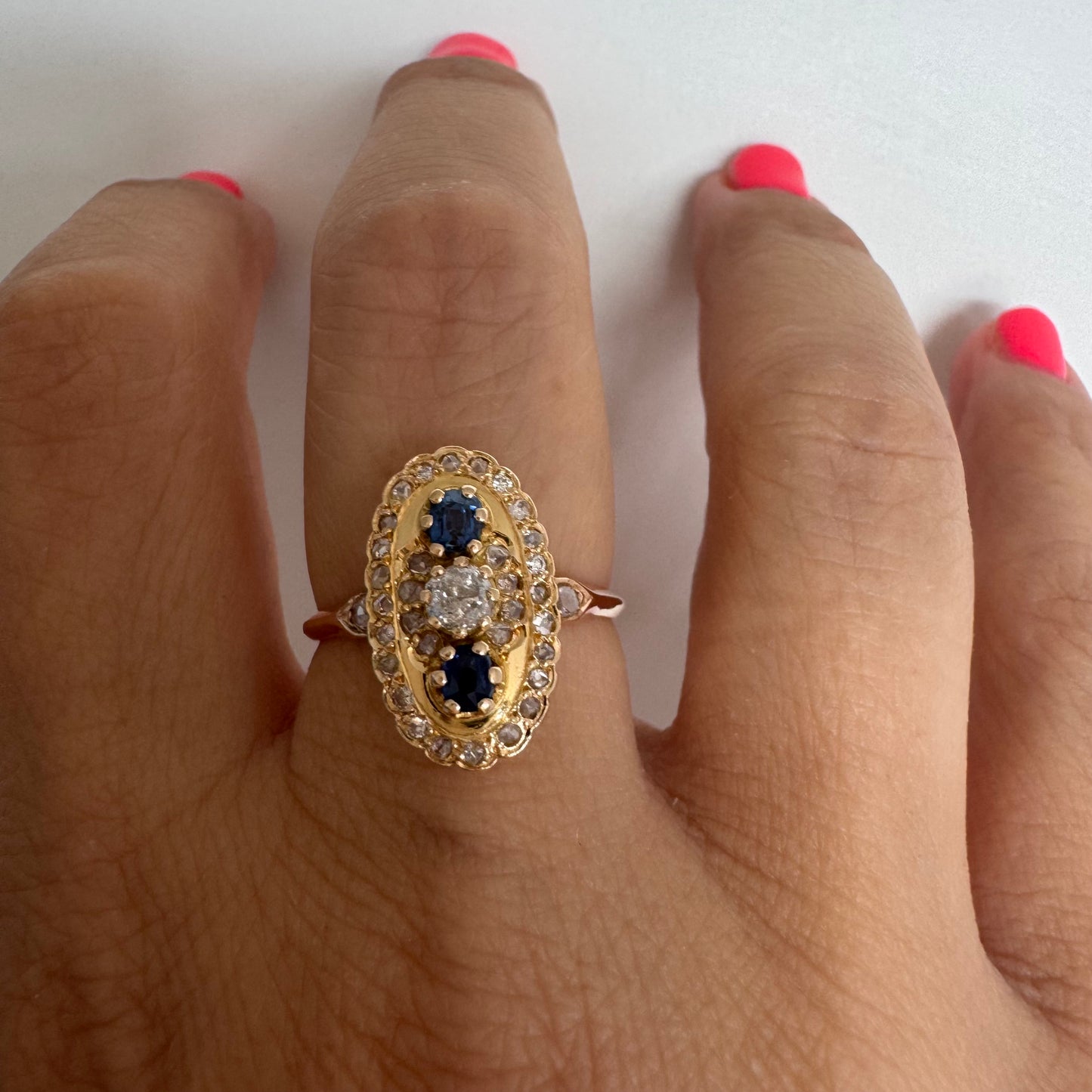 14K gold ring set with Diamonds and deep blue Sapphires in a classic oval design.