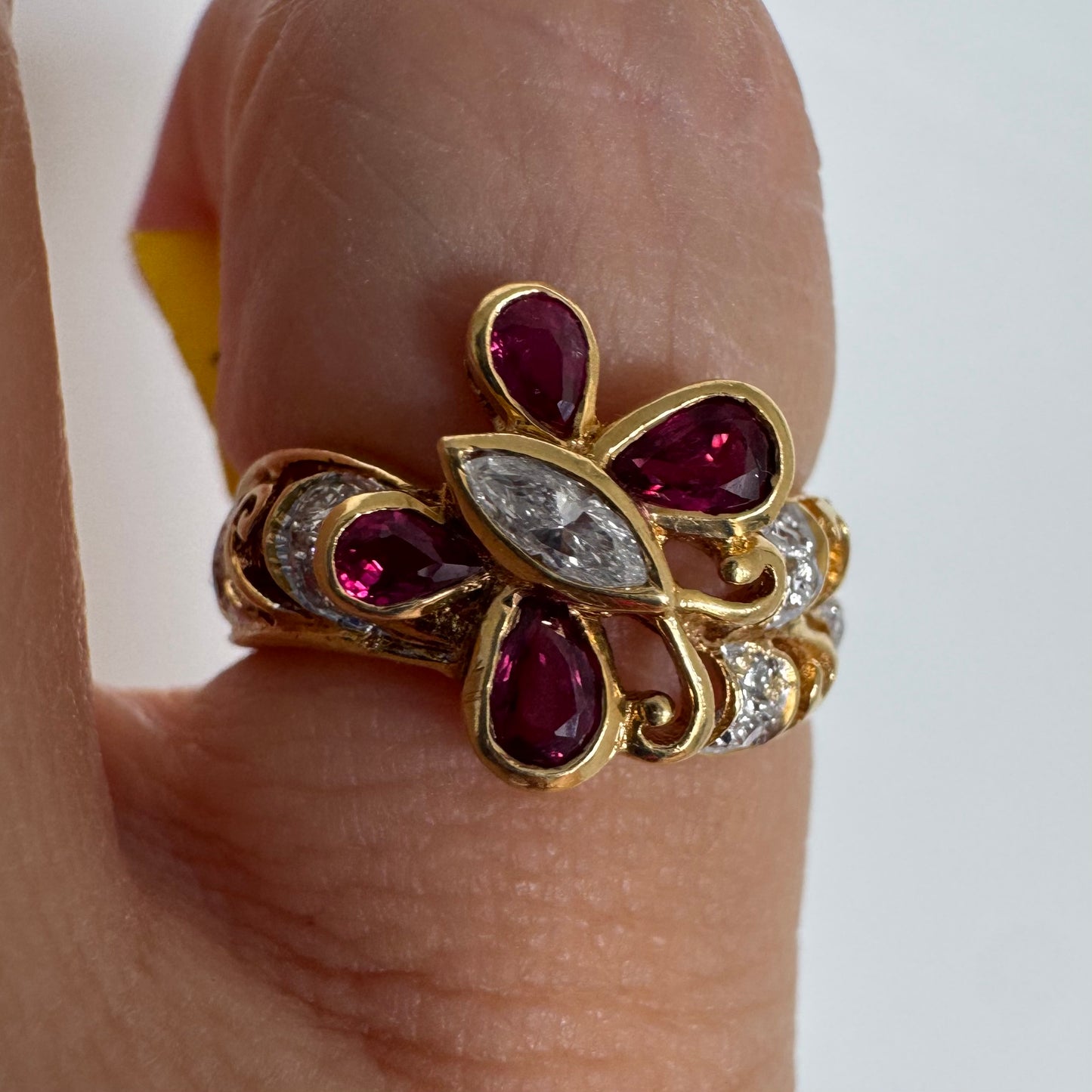 18K gold butterfly ring set with pear-cut Rubies & a marquise-cut Diamond at its center