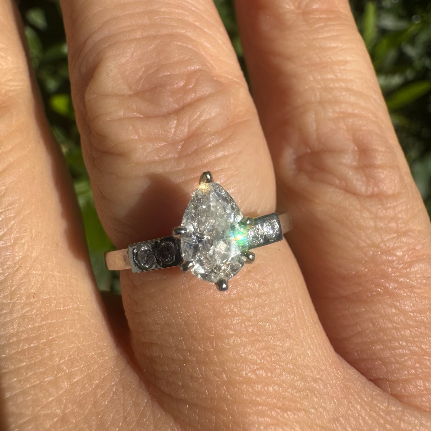 Platinum ring set with one center Pear cut Diamond & side Diamonds