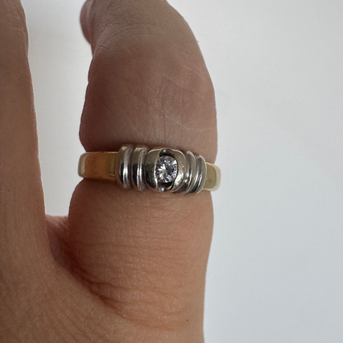14K two-tone gold ring set with a central Diamond in a clean and refined design