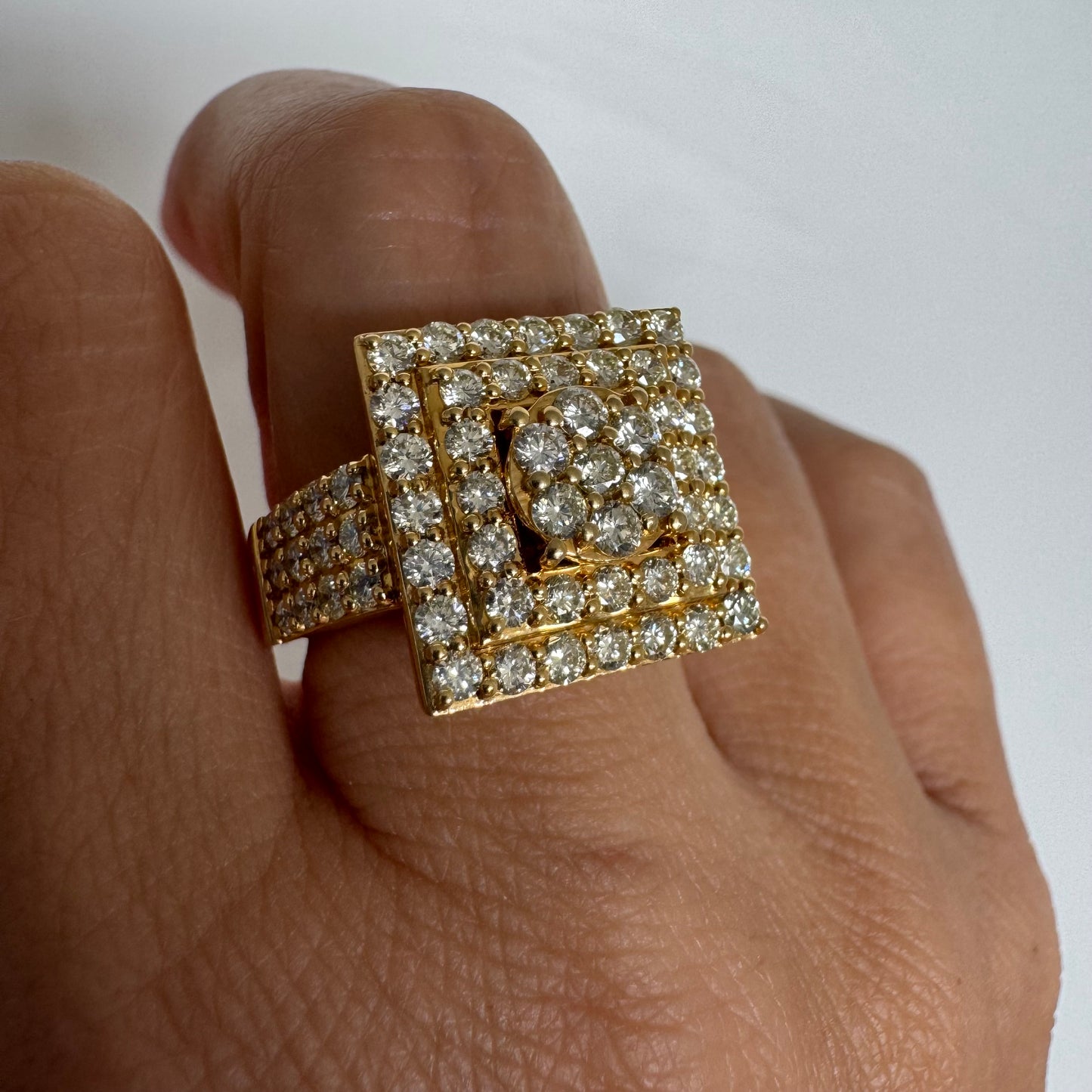10K gold ring featuring a bold geometric design beautifully set with sparkling Diamonds