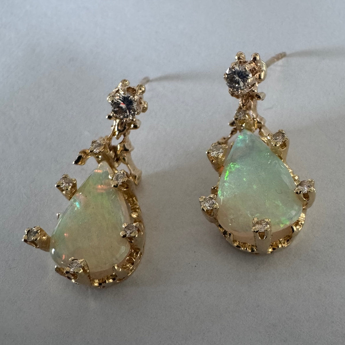 14K gold drop earrings set with pear-shaped Opals and Diamonds.