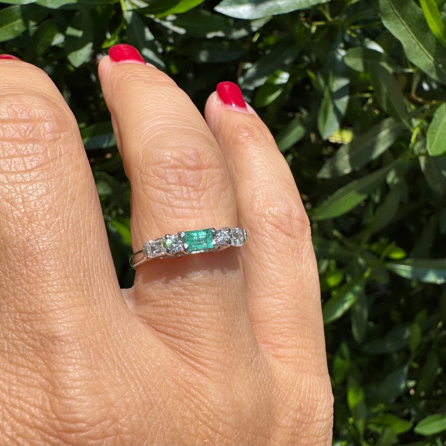 14K gold ring set with one center Emerald & Diamonds on the sides
