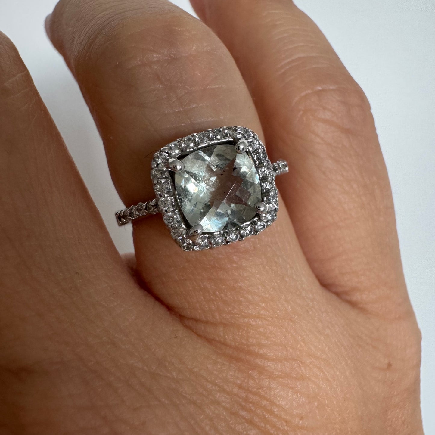 14K white gold ring featuring a cushion-cut light blue Aquamarine set in a sparkling double halo of round-cut Diamonds.