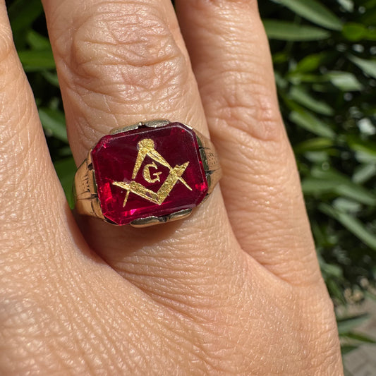 10K gold “Freemason” ring set with red gemstone with the iconic compass square and the letter “G” in gold