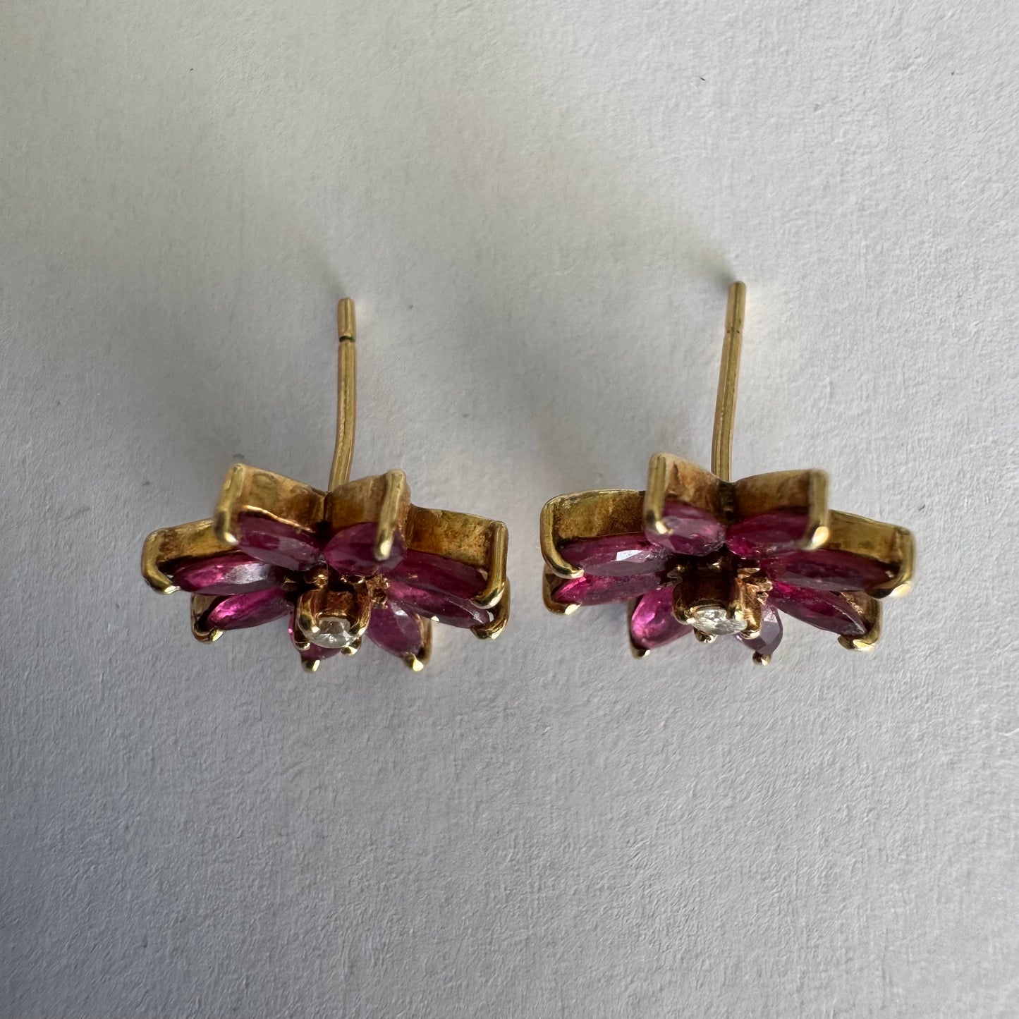 14K gold floral earrings set with marquise-cut Rubies and a small Diamond at the center