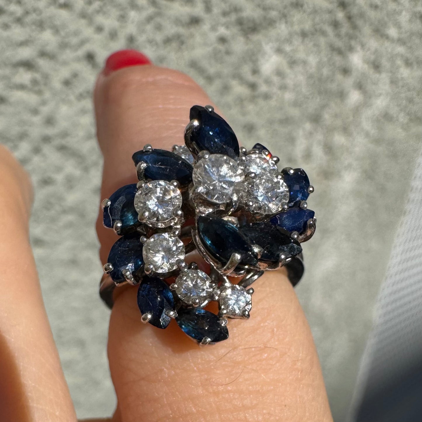 18K white gold ring, set with marquise-cut blue Sapphires and round Diamonds, in a classic cluster design.
