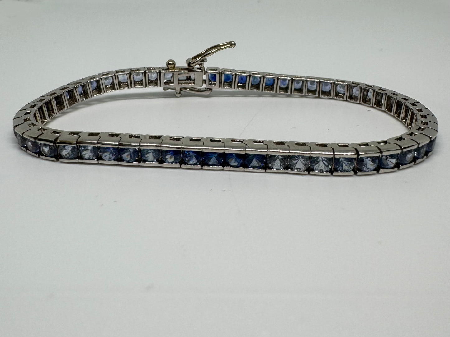 14K gold Tennis Bracelet set with different shades of Sapphire