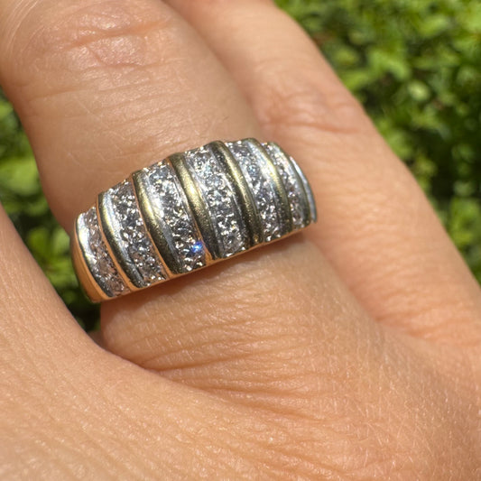 18K gold ring featuring multiple horizontal rows of sparkling Diamonds.