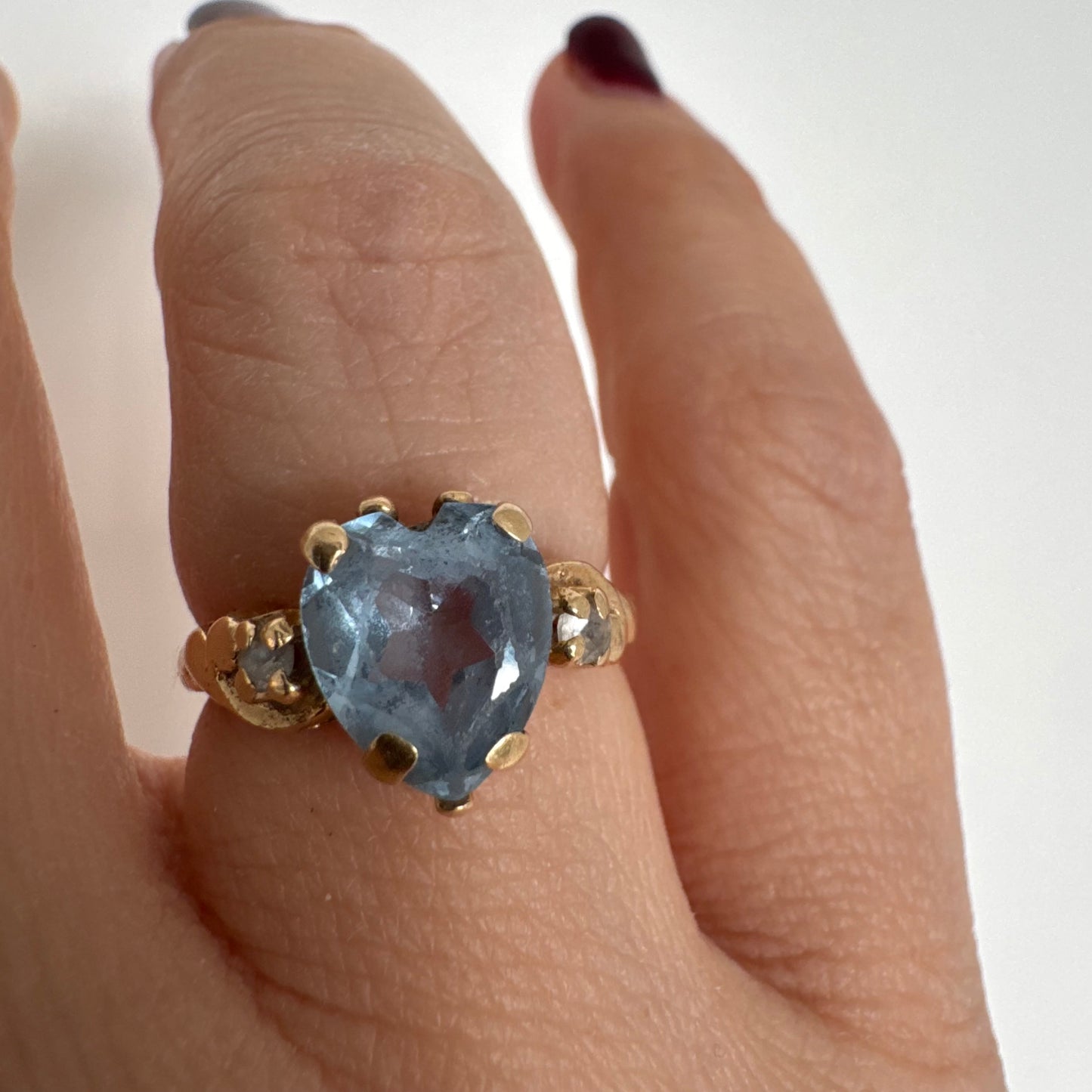 14K gold ring set with a heart-cut Blue Topaz stone