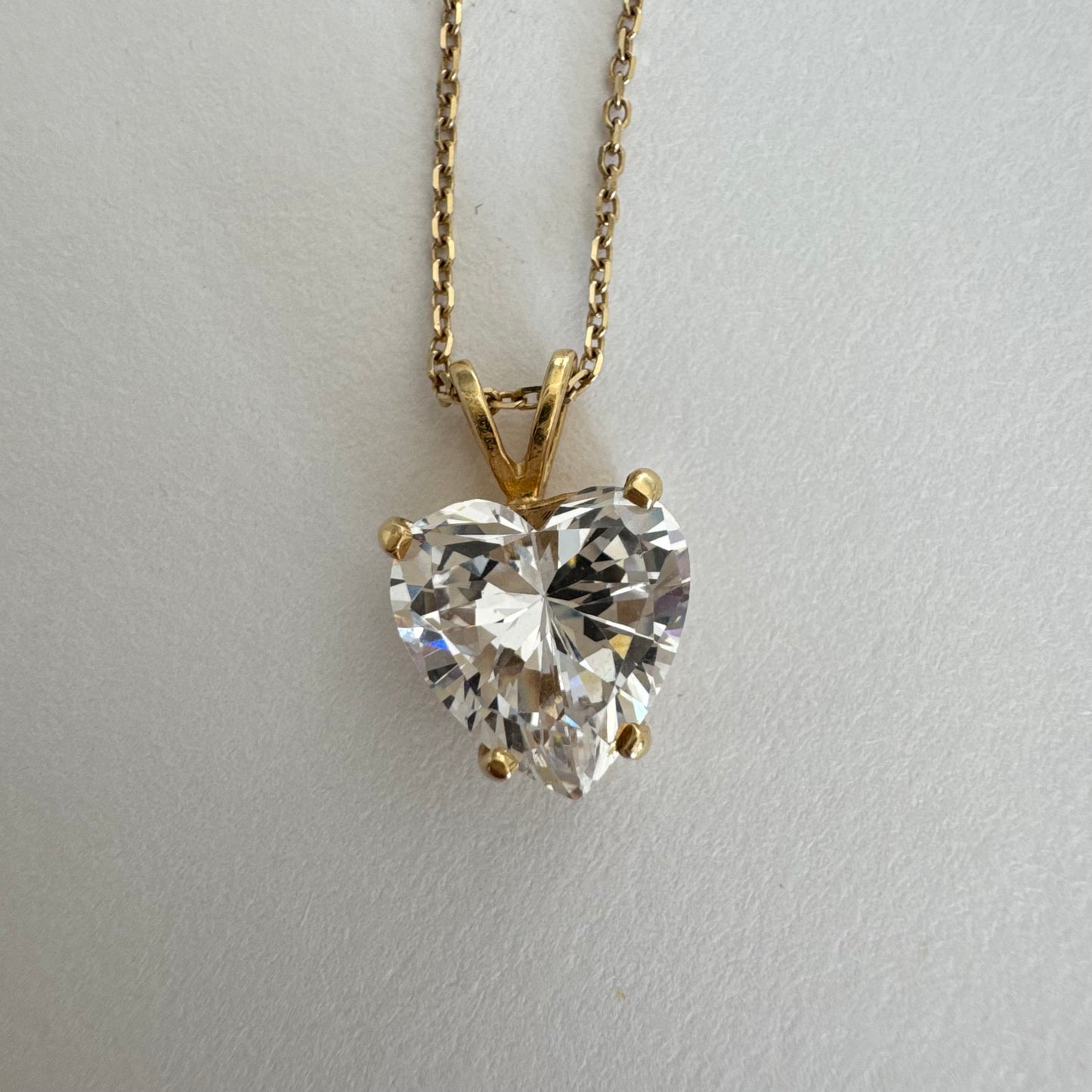 14K gold Heart Pendant set with a brilliant heart-cut clear stone.