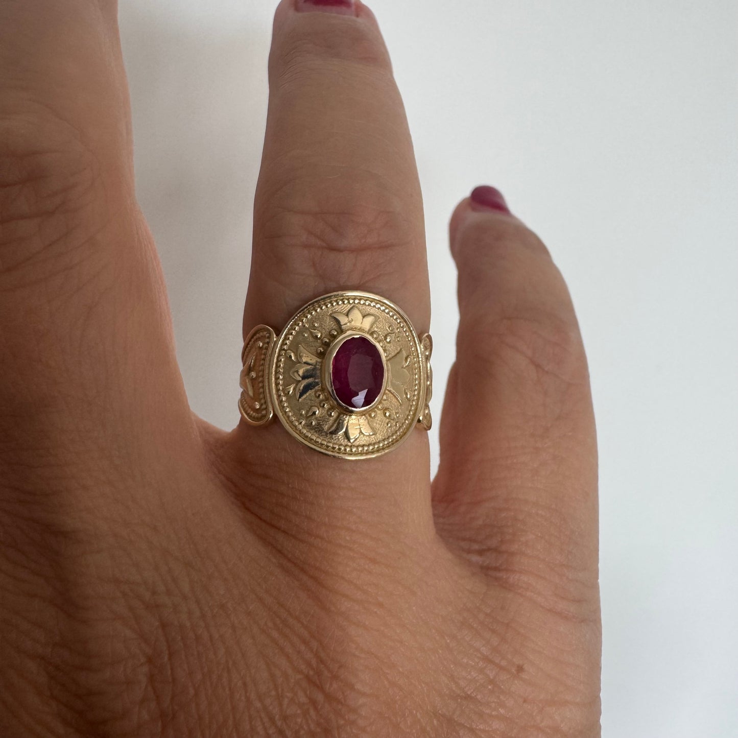 14K gold ring set with an oval Ruby