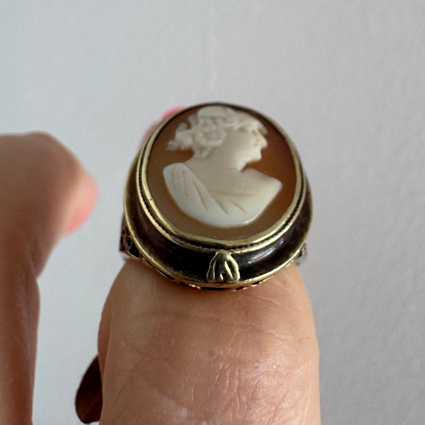 14K gold cameo ring featuring a finely carved portrait of a woman in profile, set in an oval bezel with intricate gold detailing