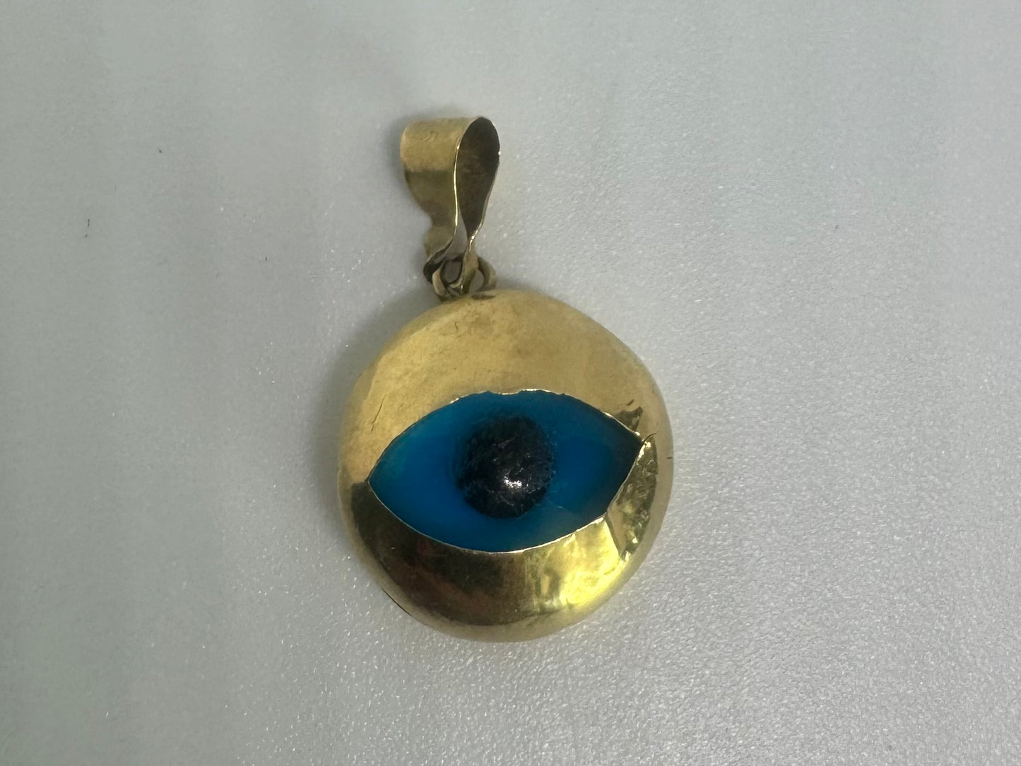 14K gold pendant set with “evil eye”