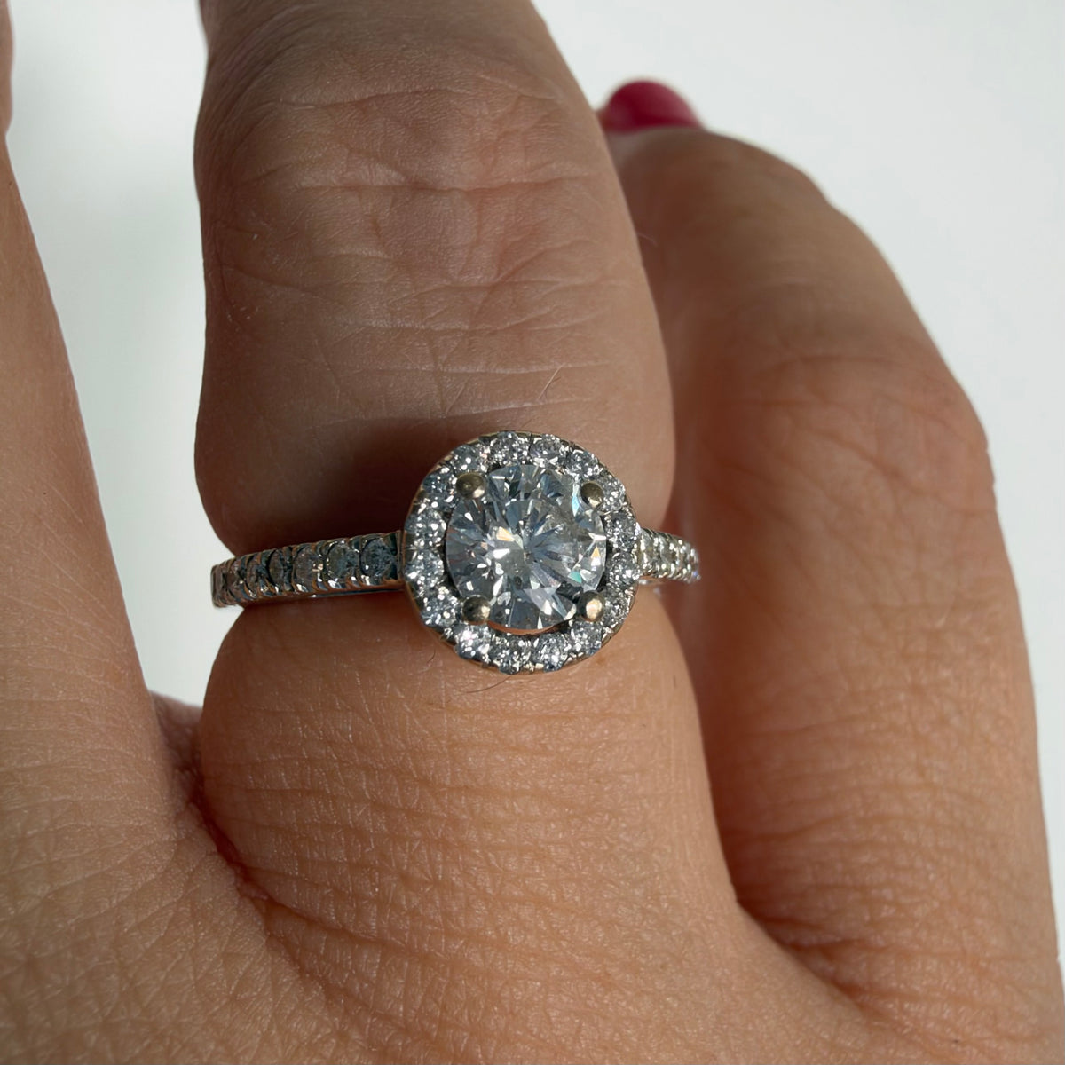14K white gold vintage ring with a round brilliant-cut diamond and diamond halo