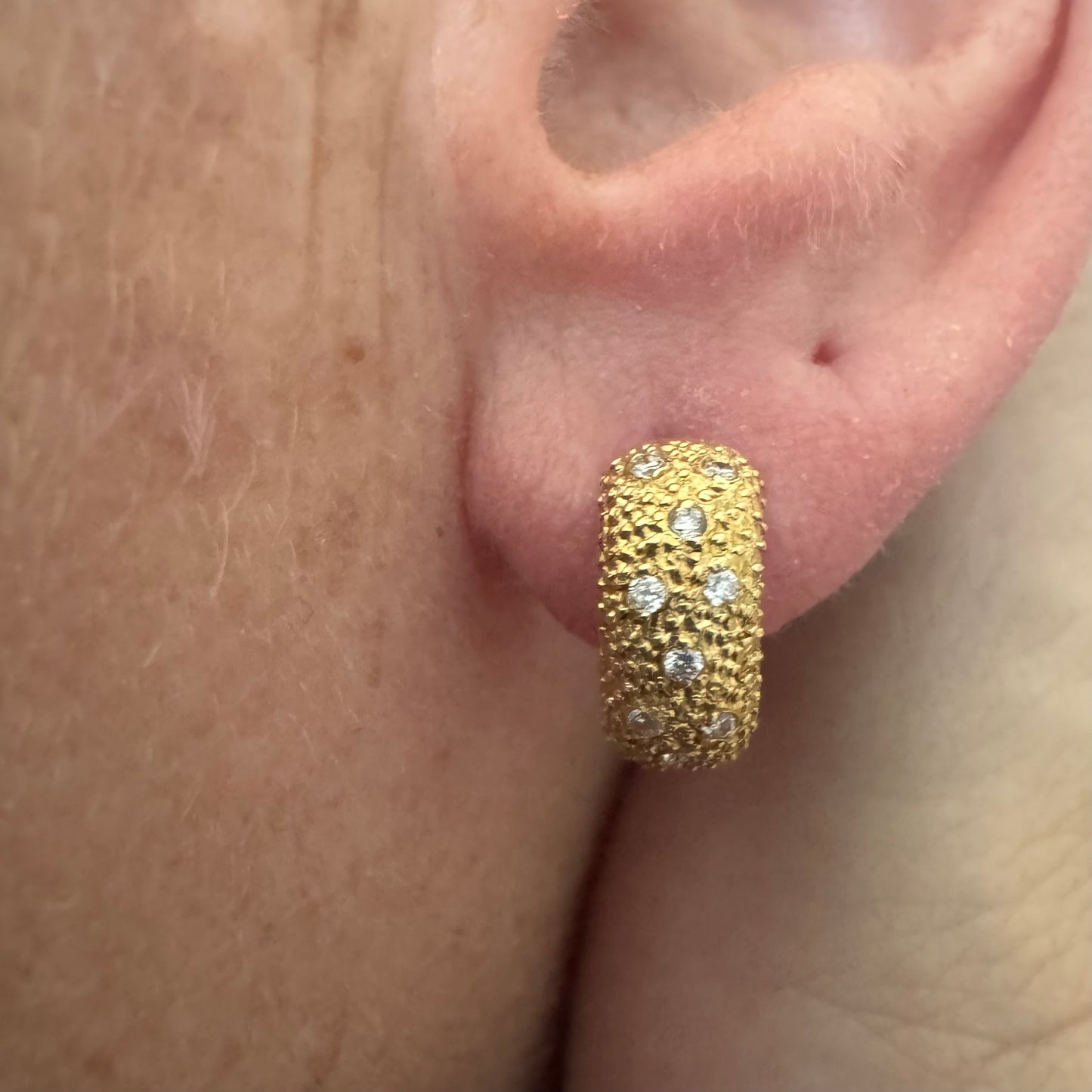 18K gold hoop earrings designed with a rich organic texture and set with Diamonds