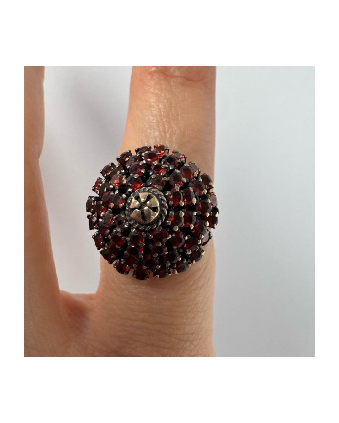 10K gold statement ring designed as a bold floral cluster set with Garnets