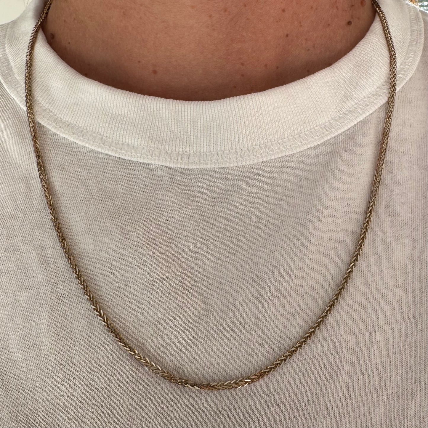 שרשרת זהב צהוב 14 קראט בעיצוב חוליות קלועות היוצרות מראה עשיר ומלא ברק.