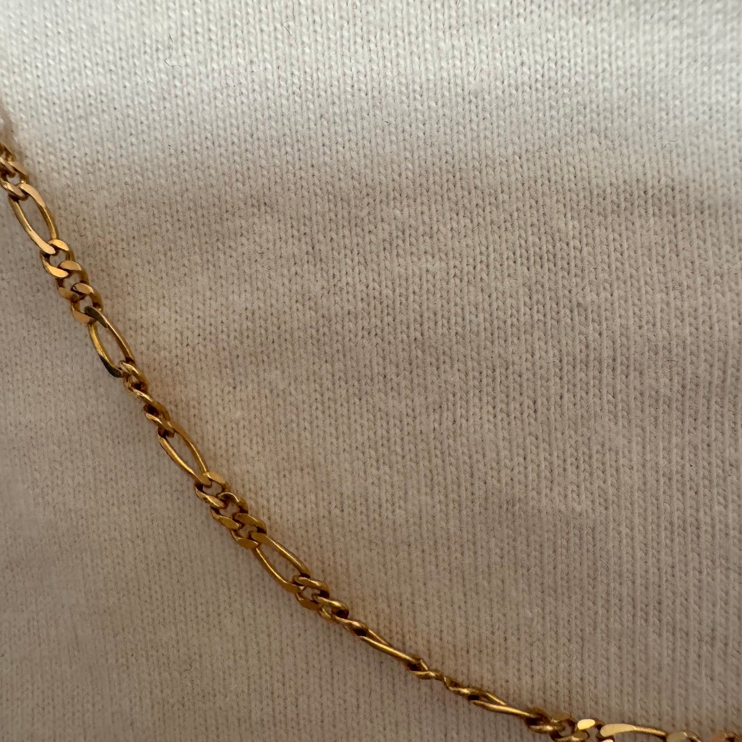 שרשרת זהב צהוב 14 קראט בעיצוב חוליות דקות ומוארכות עם טוויסט עדין שנותן לה מראה אלגנטי ונקי.