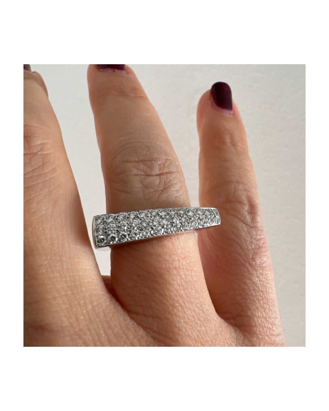 18K white gold band fully set with pavé diamonds across the surface.