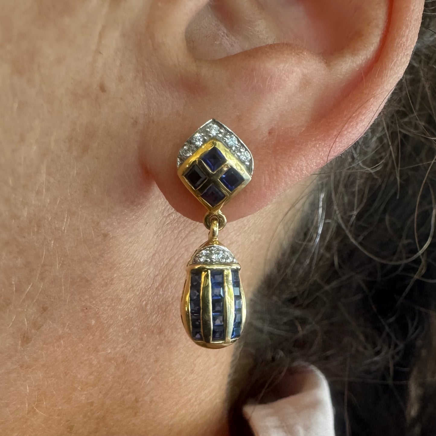18K old drop earring set with deep blue Sapphires in a geometric pattern, accented with sparkling Diamonds.