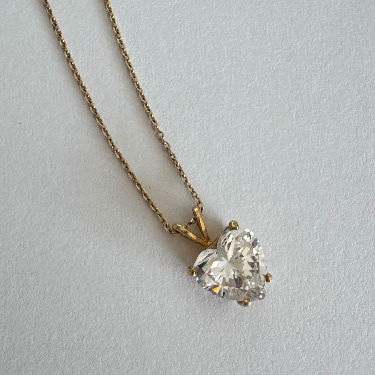 14K gold Heart Pendant set with a brilliant heart-cut clear stone.